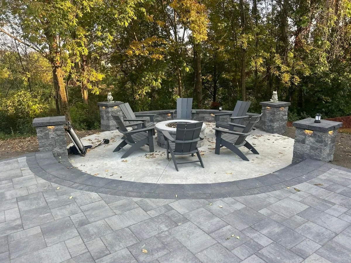 Outdoor fire pit with Adirondack seating and paver patio Capital Region NY — Capital Land Companies